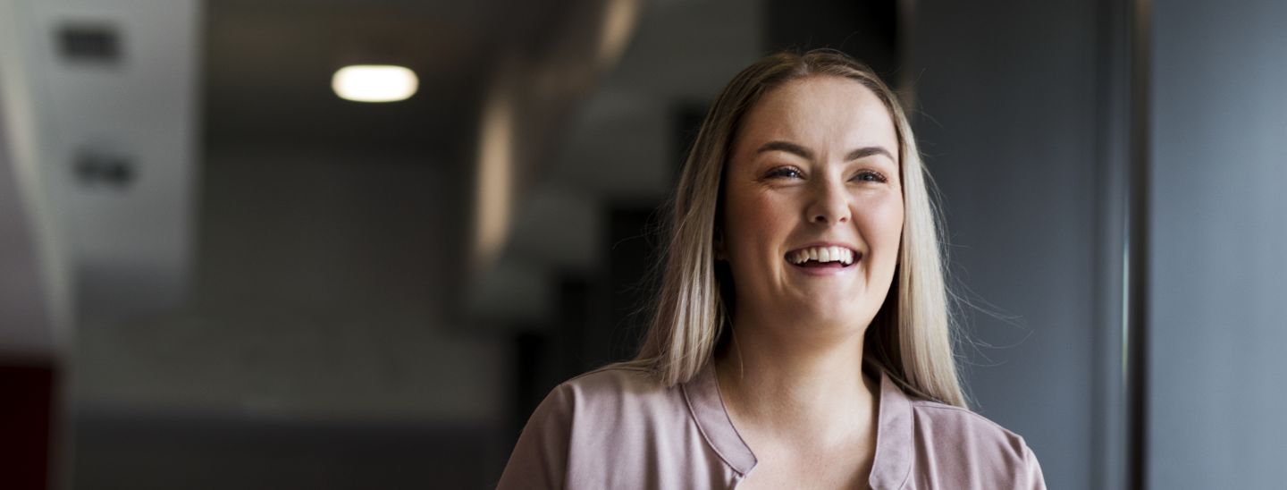 Female student on campus smiling happy