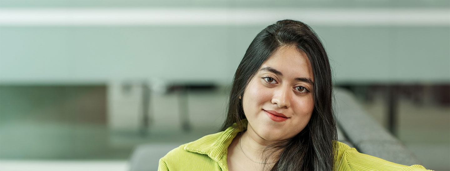 Female student sitting happy