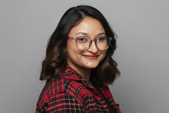 Female student wearing glasses grey background