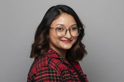 Female student wearing glasses grey background