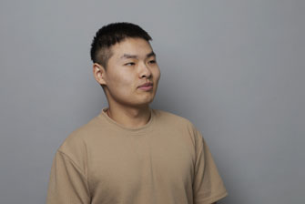 Male student on campus grey background