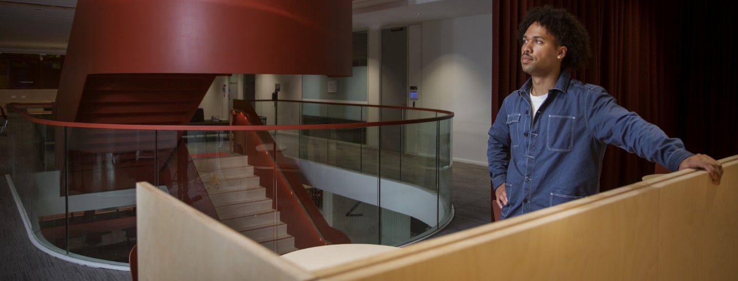 Male student waiting inside campus