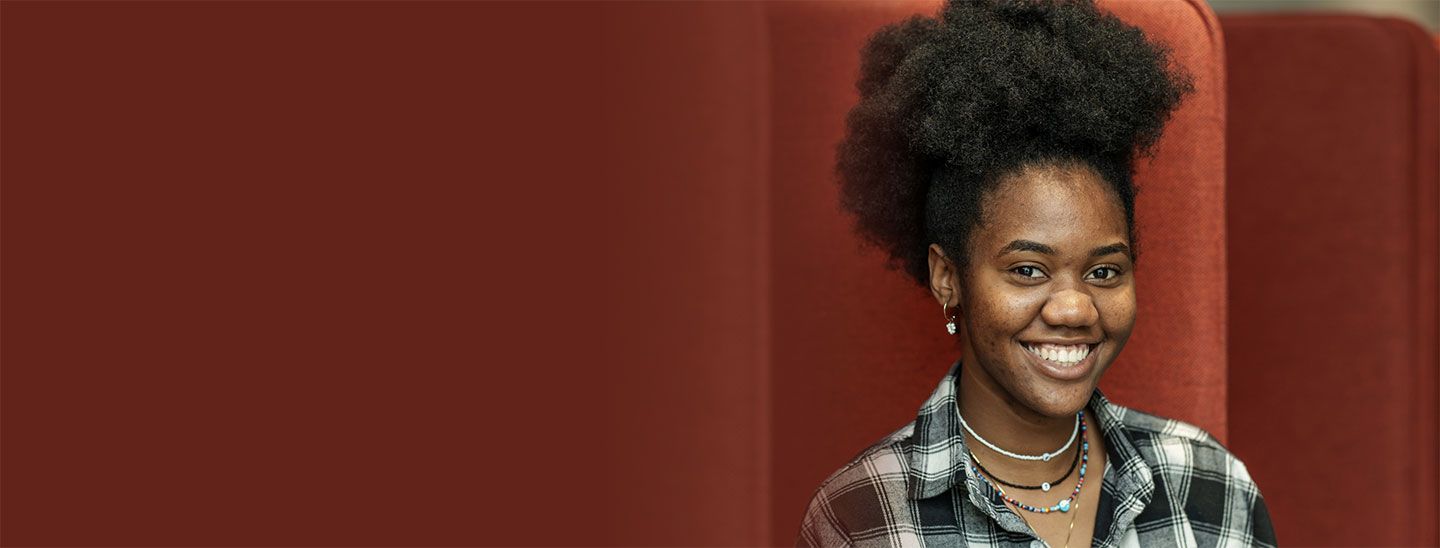 Student sitting red couch fade