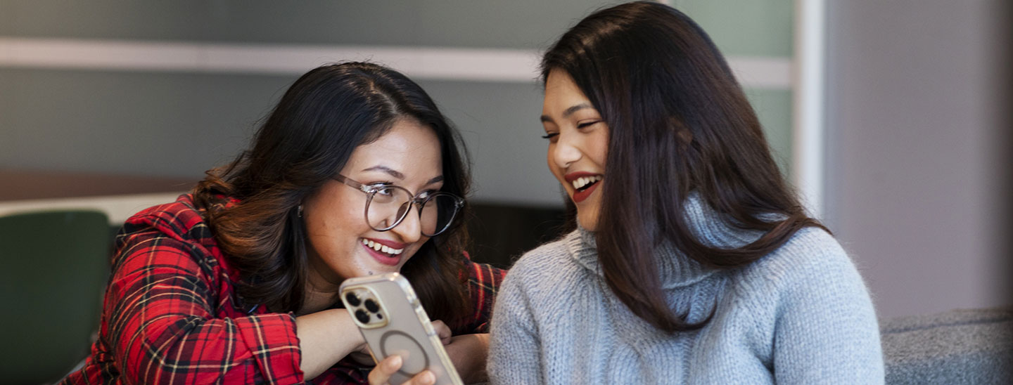 Students on campus socialising together on phone