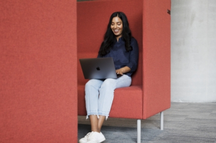 Woman student on campus using laptop