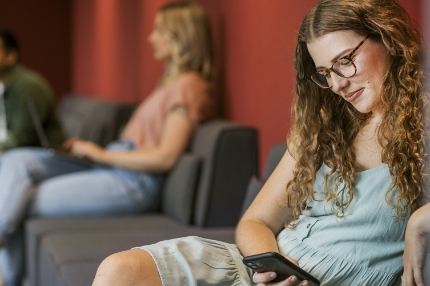 Woman student on campus using phone