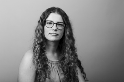 Woman student on campus wearing glasses